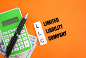 What Happens If You Get an LLC - Calculator Pen And Paper Money With The Letters Llc 