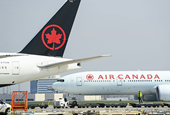 Air Canada profit cut in half in 'challenging environment'